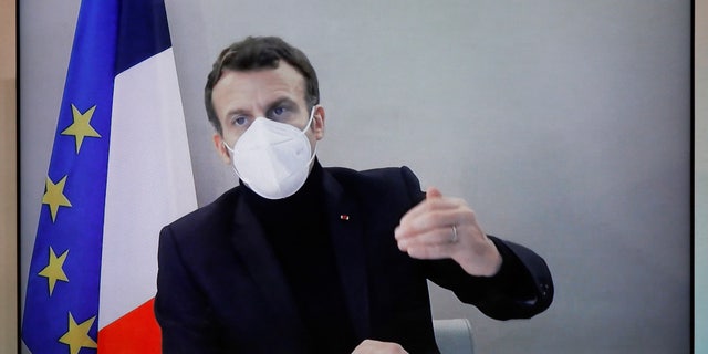 French President Emmanuel Macron is seen on screen as he attends a roundtable for the National Humanitarian Conference (NHC) in video conference, taken at the Foreign Ministry in Paris on Thursday, December 17, 2020. The French President tested positive for Emmanuel Macron. COVID-19 Thursday after a week in which he met with several European leaders. (Charles Platieu / Pool via Globe Live Media)