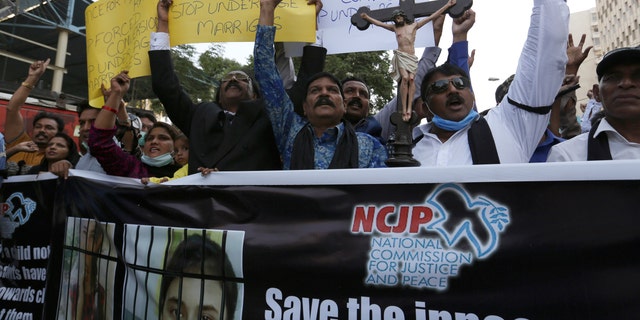 Pakistani Christians protest against child marriage and forced conversion to Islam in Karachi, Pakistan, Nov. 8, 2020. Rights groups say each year in Pakistan, as many as 1,000 girls are forcibly converted, often after being abducted or tricked. (AP Photo/Fareed Khan)