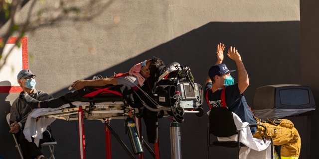 An unidentified patient receives oxygen on a stretcher outside the CHA Hollywood Presbyterian Medical Center in Los Angeles, Dec. 18, 2020. (Associated Press)