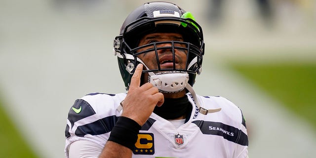 Seattle Seahawks quarterback Russell Wilson (3) points upwards before the start of the first half of an NFL football game against the Washington Football Team, Sunday, Dec. 20, 2020, in Landover, Md. (AP Photo/Andrew Harnik)