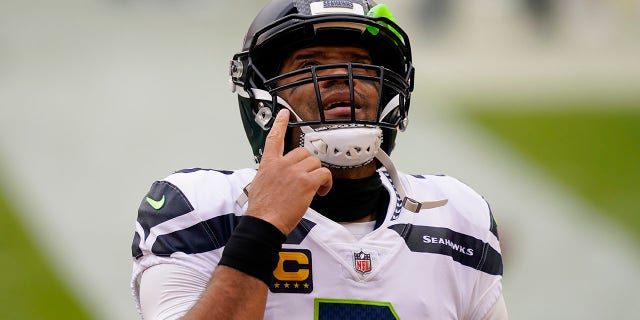 Seattle Seahawks quarterback Russell Wilson (3) points upwards before the start of the first half of an NFL football game against the Washington Football Team, Sunday, Dec. 20, 2020, in Landover, Md. (AP Photo/Andrew Harnik)