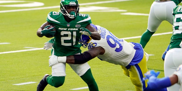 New York Jets running back Frank Gore (21) is tackled by Los Angeles Rams defensive end Michael Brockers (90) during the first half of an NFL football game Sunday, Dec. 20, 2020, in Inglewood, Calif.