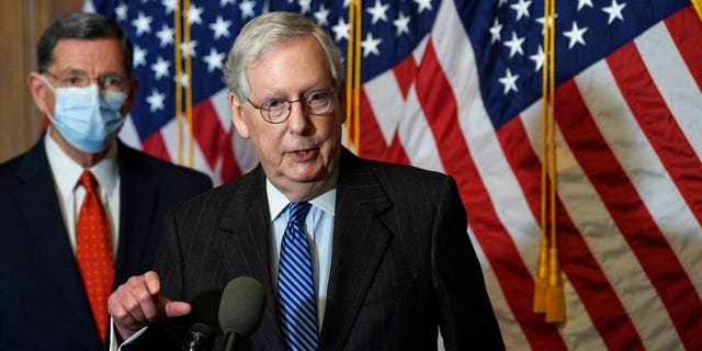 Senate Majority Leader Mitch McConnell, of Kentucky, speaks during a news conference with other Senate Republicans on Capitol Hill in Washington, while Sen. John Barrasso, R-Wyoming, listens at left. 