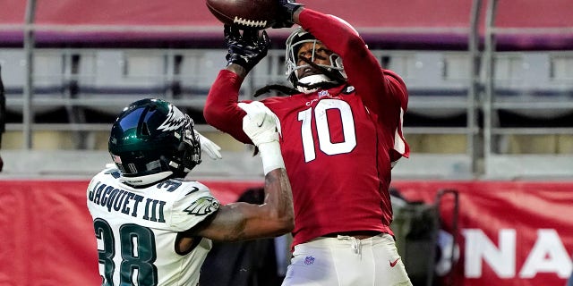 Arizona Cardinals wide receiver DeAndre Hopkins (10) scores a touchdown as Philadelphia Eagles defensive back Michael Jacquet (38) defends during the second half of an NFL football game, Sunday, Dec. 20, 2020, in Glendale, Ariz. (AP Photo/Rick Scuteri)