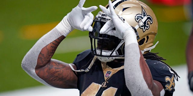 New Orleans Saints running back Alvin Kamara (41) reacts after his touchdown carry in the second half of an NFL football game against the Kansas City Chiefs in New Orleans, Sunday, Dec. 20, 2020. (AP Photo/Butch Dill)