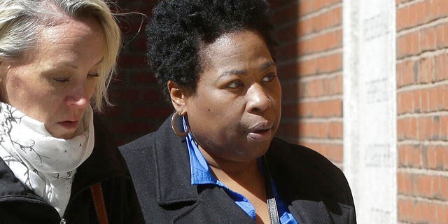 FILE: Former college entrance exam administrator Niki Williams of Houston, right, arrives at federal court in Boston to face charges in a nationwide college admissions bribery scandal.