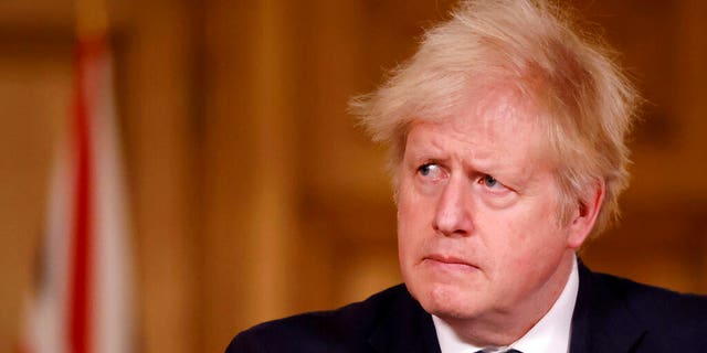 Britain's Prime Minister Boris Johnson speaks during a media briefing in Downing Street, London, Monday, Dec. 21, 2020. (Tolga Akmen/Pool via AP)