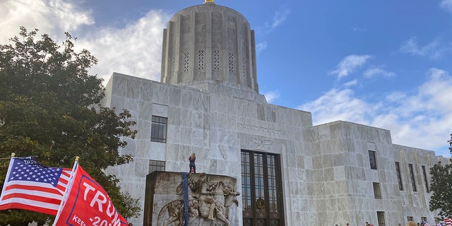 Protesters hold a rally outside the Oregon State Capitol in Salem, Ore. on Monday, Dec. 21, 2020, as legislators meet for a special session to discuss COVID-19 relief measures. (AP Photo/Sara Cline)