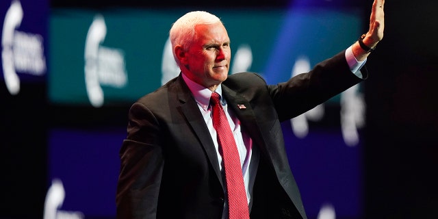 Vice President Mike Pence waves as he walks off the stage after speaking at the Turning Point USA Student Action Summit, Tuesday, Dec. 22, 2020, in West Palm Beach, Fla. (AP Photo/Lynne Sladky)