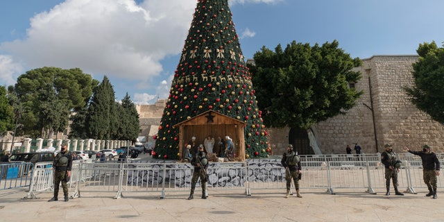 A Palestinian National security unit is deployed in Manger Square, adjacent to the Church of the Nativity, traditionally believed by Christians to be the birthplace of Jesus Christ, ahead of Christmas, in the West Bank city of Bethlehem, Wednesday, Dec. 23, 2020. (AP Photo/Nasser Nasser)