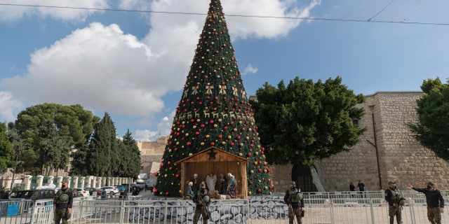 A Palestinian National security unit is deployed in Manger Square, adjacent to the Church of the Nativity, traditionally believed by Christians to be the birthplace of Jesus Christ, ahead of Christmas, in the West Bank city of Bethlehem, Wednesday, Dec. 23, 2020. (AP Photo/Nasser Nasser)