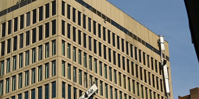 Damaged scaffolding hangs off the side of the Baltimore Gas and Electric building on Wednesday in Baltimore. Twenty-one of the victims were brought to area hospitals following the explosion with a partial roof collapse. The city’s fire department tweeted that at least nine of the victims were in critical condition, while another was in serious condition. (Jerry Jackson/The Baltimore Sun via AP)