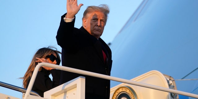 President Trump waves as he boards Air Force One at Andrews Air Force Base, Md., Dec. 23, 2020. Trump is traveling to his Mar-a-Lago resort in Palm Beach, Fla. Trump earlier this week baselessly claimed that he won the presidential election by a "magnificent landslide." (AP Photo/Patrick Semansky)
