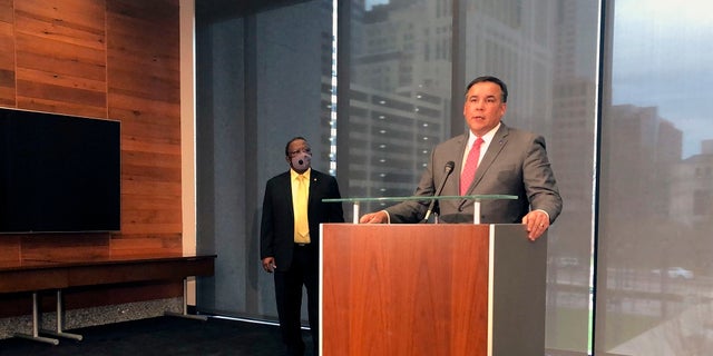 Columbus Mayor Andrew Ginther calls for the firing of a police officer seen on bodycam video shooting a Black man who was holding a cell phone, at a news conference on Wednesday in Columbus, Ohio. Ginther said the officer violated departmental policies by not turning on his camera's full audio and video functions and not helping the victim of the shooting as he lay wounded on the floor of the garage where he was shot. (AP Photo/Andrew Welsh-Huggins)