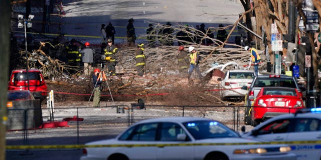 Investigators continue to examine the site of an explosion Sunday, Dec. 27, 2020, in downtown Nashville, Tenn. 