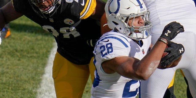 Indianapolis Colts running back Jonathan Taylor (28) runs past Pittsburgh Steelers inside linebacker Vince Williams (98) for a touchdown during the first half of an NFL football game, Sunday, Dec. 27, 2020, in Pittsburgh. (AP Photo/Gene J. Puskar)