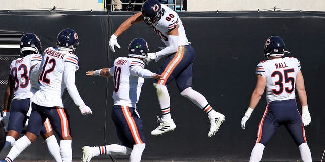 Chicago Bears tight end Jimmy Graham, second from right, celebrates his touchdown catch against the Jacksonville Jaguars with teammates Javon Wims (83), Allen Robinson II (12), quarterback Mitchell Trubisky (10) and Ryan Nall (35) during the first half of an NFL football game, Sunday, Dec. 27, 2020, in Jacksonville, Fla. (AP Photo/Stephen B. Morton)