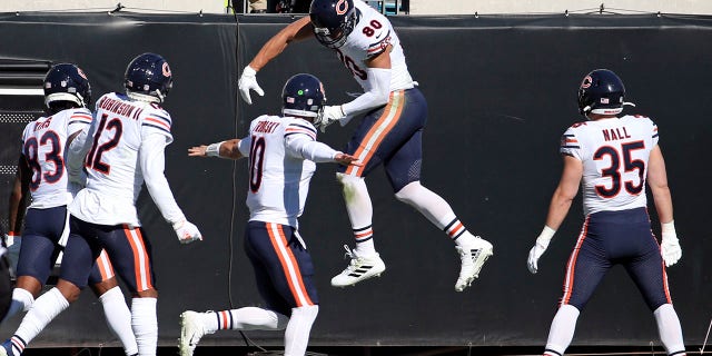 Chicago Bears tight end Jimmy Graham, second from right, celebrates his touchdown catch against the Jacksonville Jaguars with teammates Javon Wims (83), Allen Robinson II (12), quarterback Mitchell Trubisky (10) and Ryan Nall (35) during the first half of an NFL football game, Sunday, Dec. 27, 2020, in Jacksonville, Fla. (AP Photo/Stephen B. Morton)