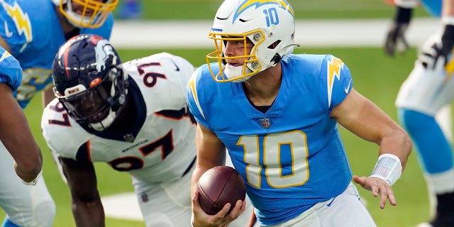 Los Angeles Chargers quarterback Justin Herbert (10) runs against the Denver Broncos during the first half of an NFL football game Sunday, Dec. 27, 2020, in Inglewood, Calif. (AP Photo/Ashley Landis)