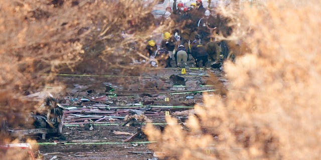 Investigators continue to look through the site of an explosion Monday, Dec. 28, 2020, in Nashville, Tenn.