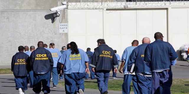 In this Feb. 26, 2013, file photo, inmates walk through the exercise yard at California State Prison Sacramento, near Folsom, Calif. The California Supreme Court ruled Monday, Dec. 28, 2020, that inmates convicted of what the state defines as nonviolent sex crimes cannot be denied a chance at earlier release under a ballot measure approved by nearly two-thirds of voters four years ago.