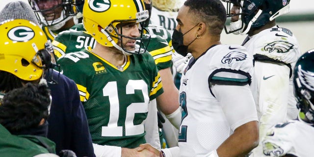 Green Bay Packers' Aaron Rodgers shakes hands with Philadelphia Eagles' Jalen Hurts after an NFL football game Sunday, Dec. 6, 2020, in Green Bay, Wis. The Packers won 30-16. (AP Photo/Mike Roemer)