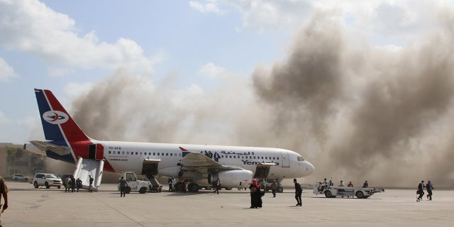 Dust rises after explosions hit Aden airport upon the arrival of the newly-formed Yemeni government, on Dec. 30. (Reuters)