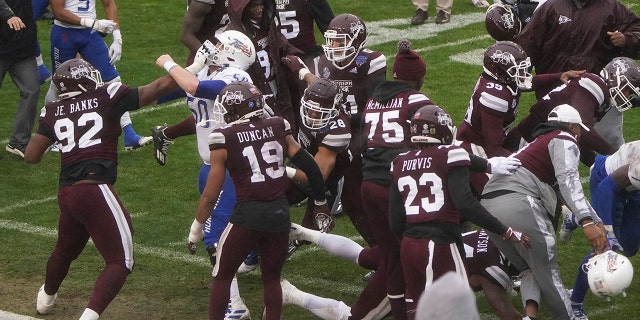 Members of Tulsa and Mississippi State fight after time runs out in the Armed Forces Bowl NCAA college football game Thursday, Dec. 31, 2020, in Fort Worth, Texas. (AP Photo/Jim Cowsert)