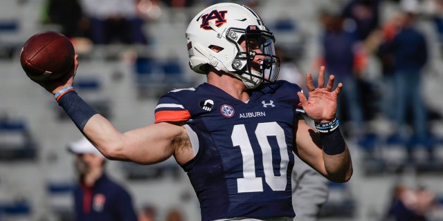 Auburn quarterback Bo Nix (10) warming up before the start of a game last December.