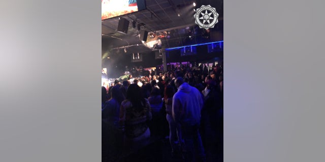 Patrons attend the Aftermath nightclub for a concert that violated COVID-19 restrictions.