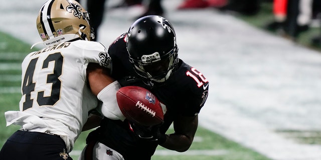 New Orleans Saints free safety Marcus Williams (43) punches Atlanta Falcons wide receiver Calvin Ridley (18) during a December 2020 game in Atlanta.