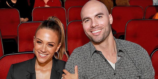 Mike Caussin and Jana Kramer sit in a theater together
