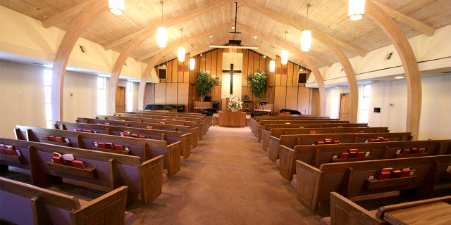 Sanctuary of a small church with pews and pulpit