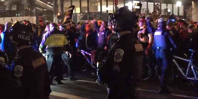 A heavy police presence was seen after nightfall in Washington D.C. as Trump supporters and far-left demonstrators flooded the streets on Saturday, Dec. 12. 