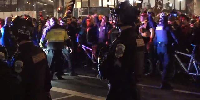 A heavy police presence was seen after nightfall in Washington D.C. as Trump supporters and far-left demonstrators flooded the streets on Saturday, Dec. 12. 