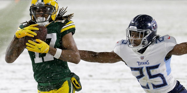 Green Bay Packers' Davante Adams catches a touchdown pass during the first half of an NFL football game against the Tennessee Titans Sunday, Dec. 27, 2020, in Green Bay, Wis. (AP Photo/Mike Roemer)