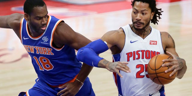 Detroit Pistons guard Derrick Rose (25) drives to the basket against New York Knicks guard Alec Burks (18) during the first half of an NBA basketball game Sunday, Dec. 13, 2020, in Detroit. (AP Photo/Duane Burleson)