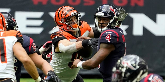 Houston Texans quarterback Deshaun Watson (4) fumbles the football as he is hit by Cincinnati Bengals' Sam Hubbard (94) during the second half of an NFL football game Sunday, Dec. 27, 2020, in Houston. The Bengals recovered the fumble. (AP Photo/Eric Christian Smith)