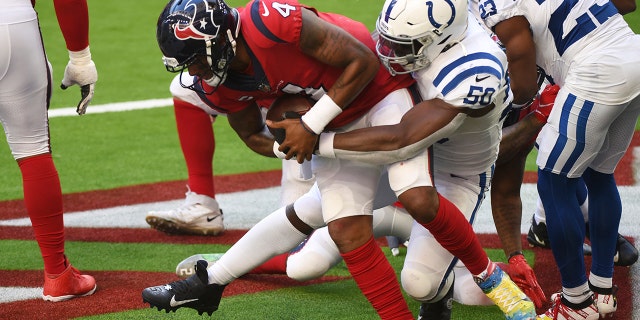 Houston Texans quarterback Deshaun Watson (4) is sacked by Indianapolis Colts defensive end Justin Houston (50) for a safety during the second half of an NFL football game Sunday, Dec. 6, 2020, in Houston. (AP Photo/Eric Christian Smith)
