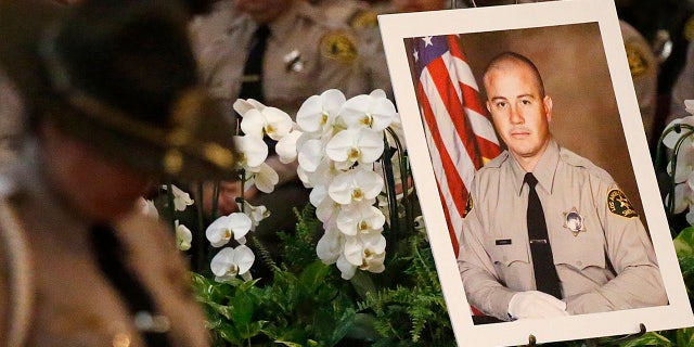 A portrait sits next to the casket of Los Angeles County Sheriffs Deputy Joseph Solano during a memorial service Monday morning June 24, 2019 at Cathedral of Our Lady of the Angels in Los Angeles. (Al Seib / Los Angeles Times via Getty Images)