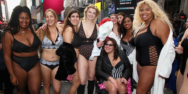 Khrystyana and other models pose for a photo in Times Square for 'The Real Catwalk' on December 1, 2018, in New York City.