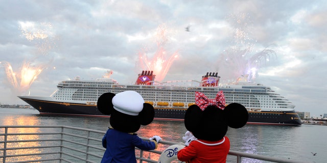 Mickey Mouse and Minnie Mouse look on as the Disney Dream sails into her home port of Port Canaveral, Fla.