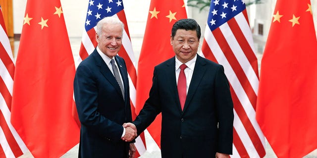 Chinese President Xi Jinping (R) shake hands with then-U.S Vice President Joe Biden (L) inside the Great Hall of the People on December 4, 2013 in Beijing, China. (Photo by Lintao Zhang/Getty Images)