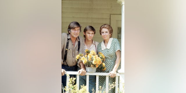 From left, Ralph Waite (as John Walton), Richard Thomas (as John Boy Walton) and Michael Learned (as Olivia Walton) in "The Waltons," circa 1974.