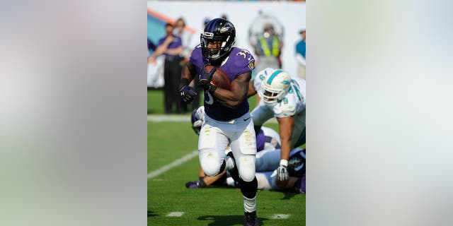 Baltimore Ravens, running back Lorenzo Taliaferro (34), ran with the ball during an NFL football game against the Miami Dolphins at Sun Life Stadium in Miami Gardens, Fla., On December 7, 2014 (Getty Images)