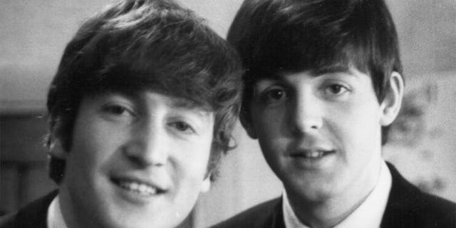 Paul McCartney and John Lennon (1940-1980) from The Beatles posed backstage at the Finsbury Park Astoria, London during the band's Christmas Show residency on December 30, 1963.