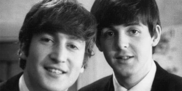 The Beatles' Paul McCartney and John Lennon (1940-1980) posed backstage at Finsbury Park Astoria, London, during the group's Christmas Show residency on December 30, 1963.