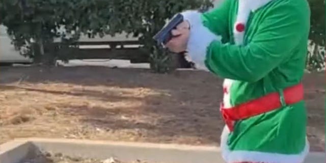 The image in the video of a secret officer dressed as a festive elf with a gun to a car thief suspect.  (Riverside Police Headquarters)