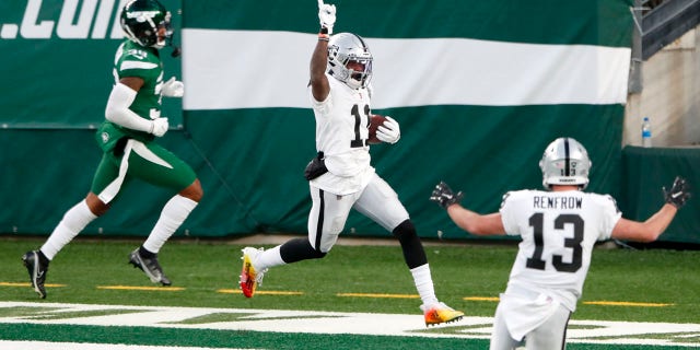 Las Vegas Raiders' Henry Ruggs III, center, celebrates his touchdown during the second half an NFL football game against the New York Jets, Sunday, Dec. 6, 2020, in East Rutherford, N.J. (AP Photo/Noah K. Murray)