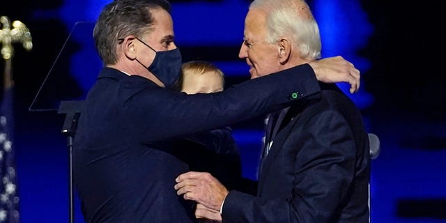 FILE - In this Nov. 7, 2020, file photo, President-elect Joe Biden, right, embraces his son Hunter Biden, left, in Wilmington, Del. Biden’s son Hunter says he has learned from federal prosecutors that his tax affairs are under investigation. (AP Photo/Andrew Harnik, Pool)